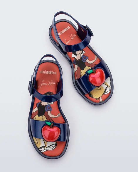 Top view of a pair of metallic blue Mini Melissa Mar Sandal Princess sandals with an apple detail on the front strap, an ankle strap and Princess Snow White soul