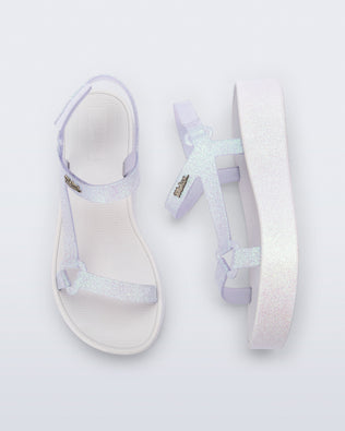 Angled and side view of a pair of white glitter Sun Downtown Platform sandals