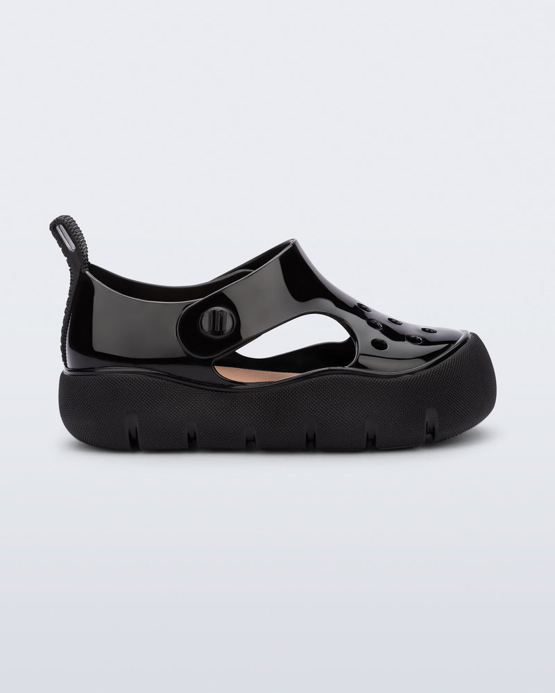 Side view of a black Bowie baby sandal.