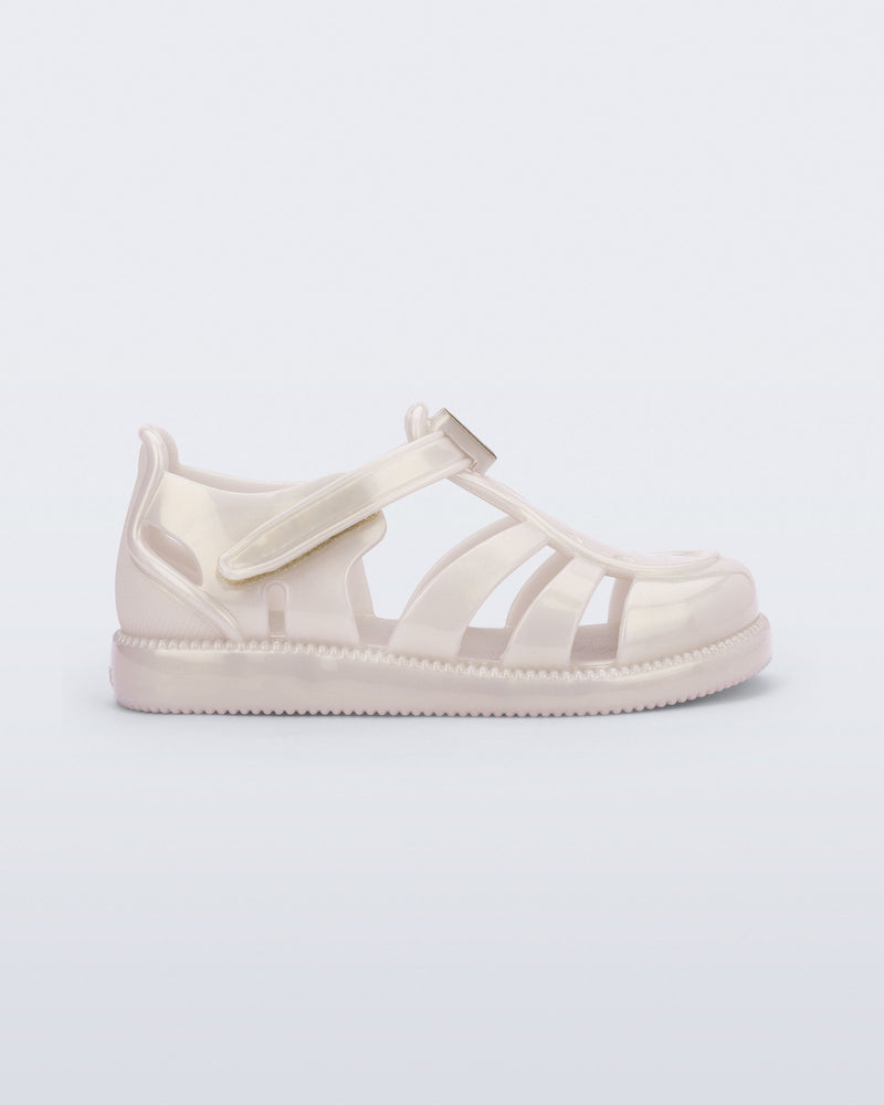 Side view of a metallic beige baby Hip Daydream sandal
