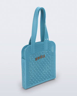 Angled view of a blue Harper bag with shoulder straps