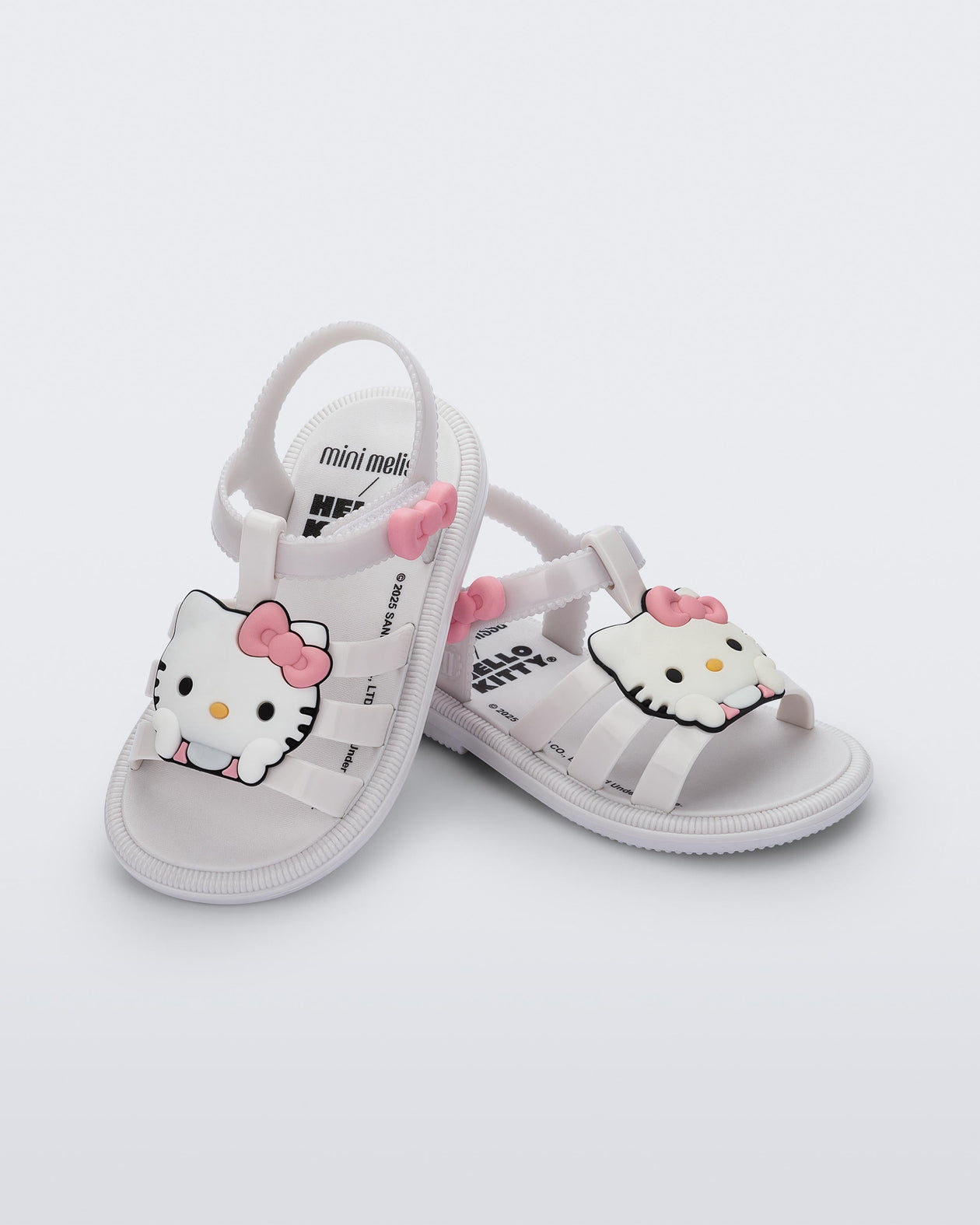Angled view of a pair of white Hip + Hello Kitty and Friends sandals with Hello Kitty on upper
