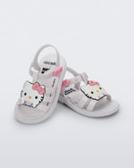 Angled view of a pair of white Hip + Hello Kitty and Friends sandals with Hello Kitty on upper