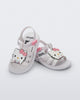 Angled view of a pair of white Hip + Hello Kitty and Friends sandals with Hello Kitty on upper