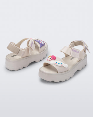 Back and angled view of a pair of beige Kick Off Sandals + Hello Kitty and Friends with Hello Kitty and Friends on the upper strap