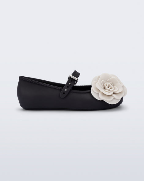 Side view of a black Soft Ballerina Petals kids flat with beige flowers