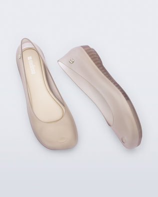 Side and top view of a pair of clear beige Ultragirl Futura ballerina flats