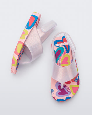 Top and side view of a pair of pink glitter Shiny baby sandals with multicolor sole