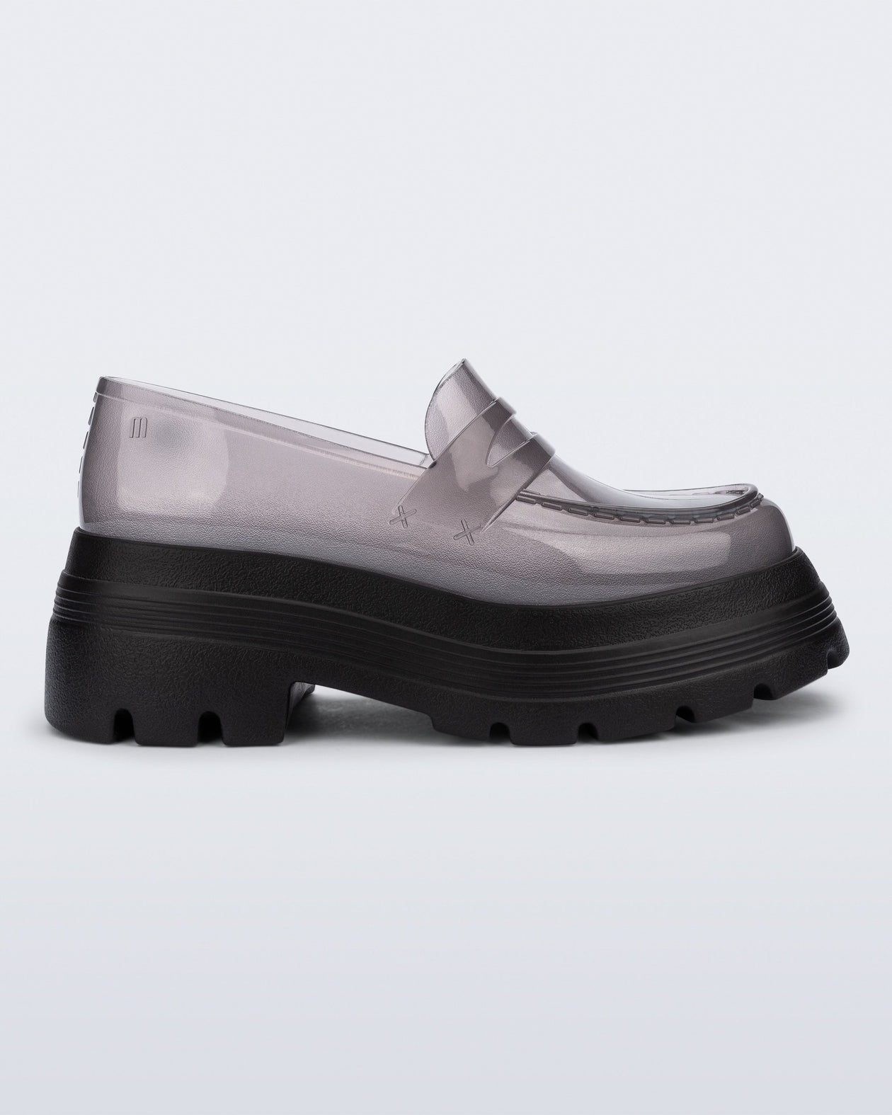 Side view of a transparent smoke Royal High + Undercover platform loafer with black sole.