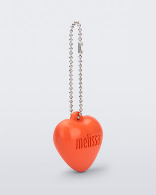Angled view of an orange Heart Charm