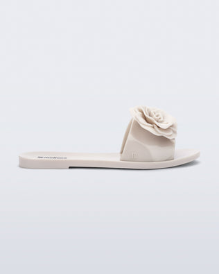 Side view of a beige Babe Petals slide sandal
