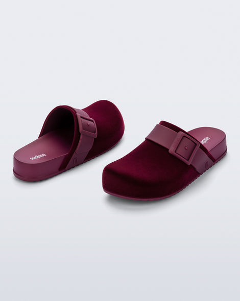 Back and front angled view of a pair of red Cozy Clog Velvet slides