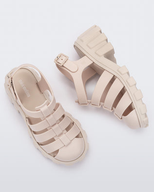 Side and top view of a pair of beige Megan kids heel sandals.