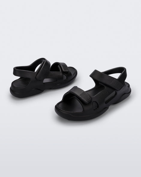 Angled view of a pair of black Free Papete sandals