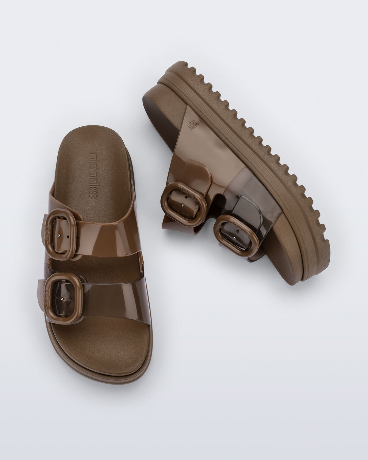 Side and top view of a pair of brown Cozy Platform kids slides with two straps with buckles, one clear brown