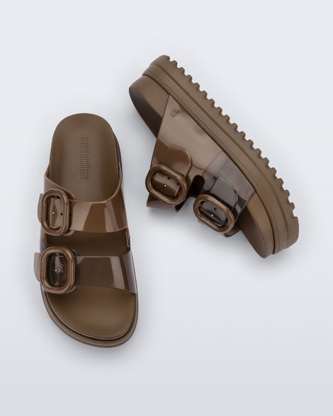 Side and top view of a pair of brown Cozy Platform kids slides with two straps with buckles, one clear brown