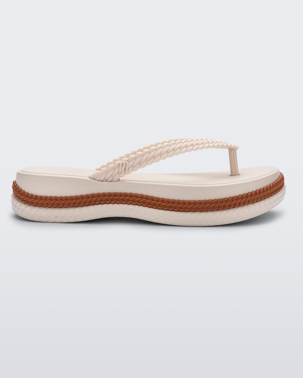 Side view of a beige/brown Melissa Leblon platform flip flop with details that mimic sisal braids on the sole and strap