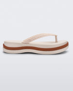Side view of a beige/brown Melissa Leblon platform flip flop with details that mimic sisal braids on the sole and strap