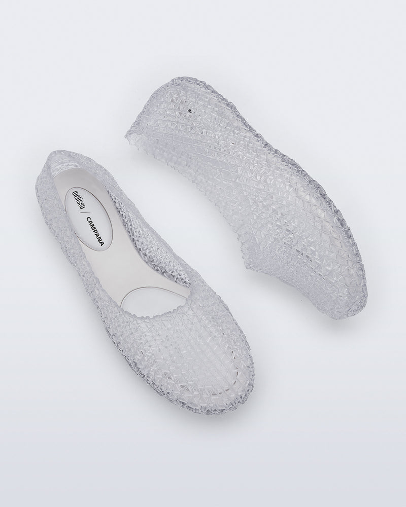Top and side view of a pair of clear Campana Papel Hug flats