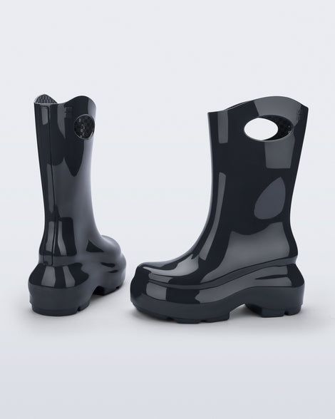 Back and side view of a pair of grey Ultra platform rain Boot with circle cutout on top