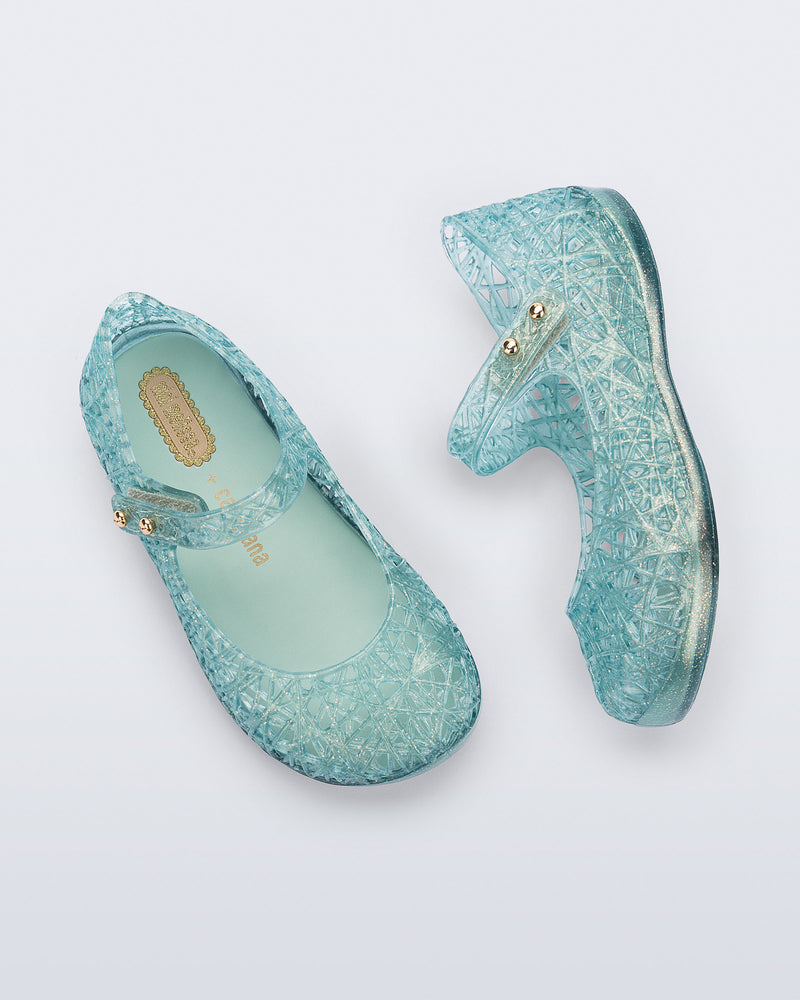 Top and side view of a pair of glitter blue green Campana Zip Zag baby flats