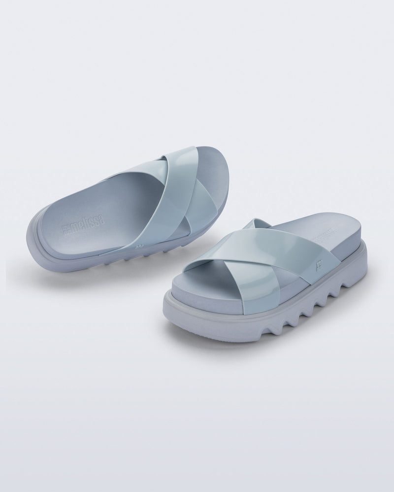 Top and angled view of a pair of blue Cozy Cross platform sandals with crisscross top straps