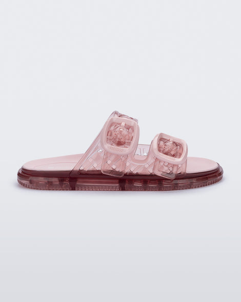 Side view of a pair of transparent pink Possession Slip sandal with two top straps