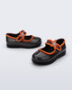 Side and angled view of a pair of glitter black Hip Ballerina Star baby flats with star on upper strap