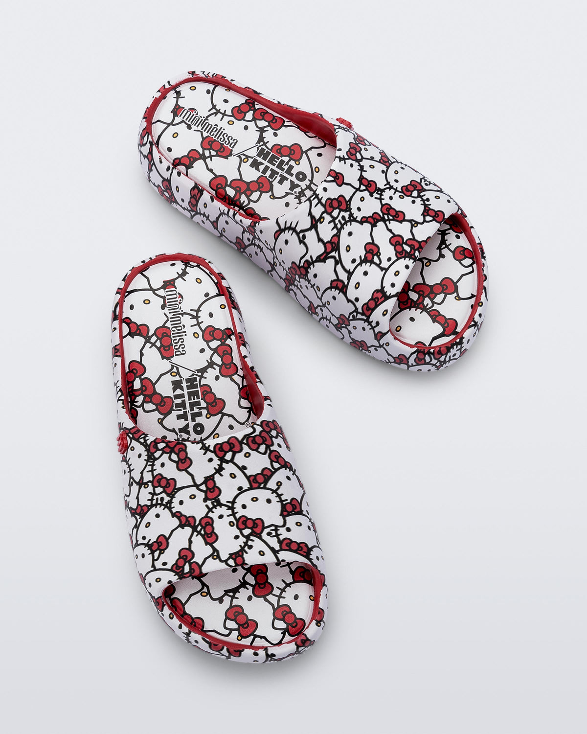 Top view of a pair of red Free Platform slides + Hello Kitty and Friends kids sandals with Hello Kitty print