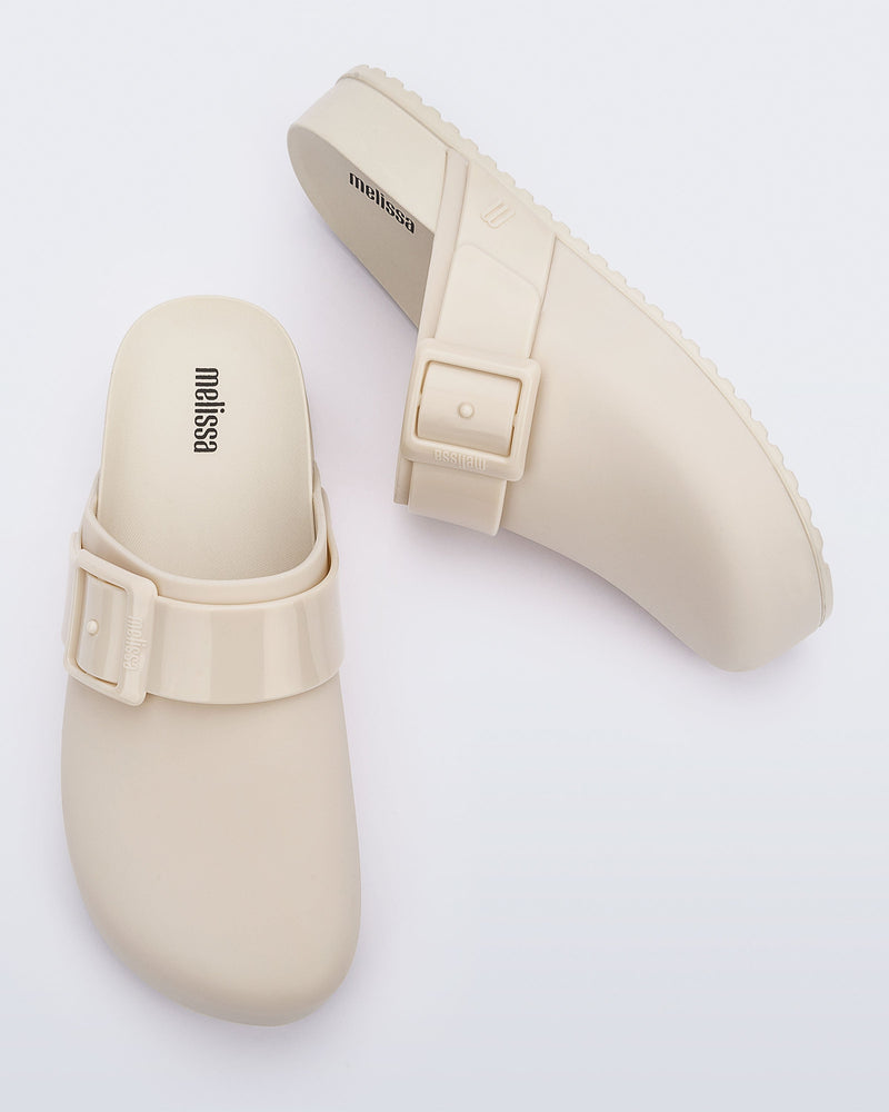 Top and side view of a pair of beige adult Cozy Clog.