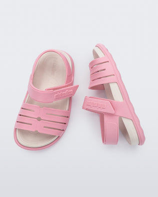 Top and side view of a pair of pink with white insole Kaiteki baby sandals