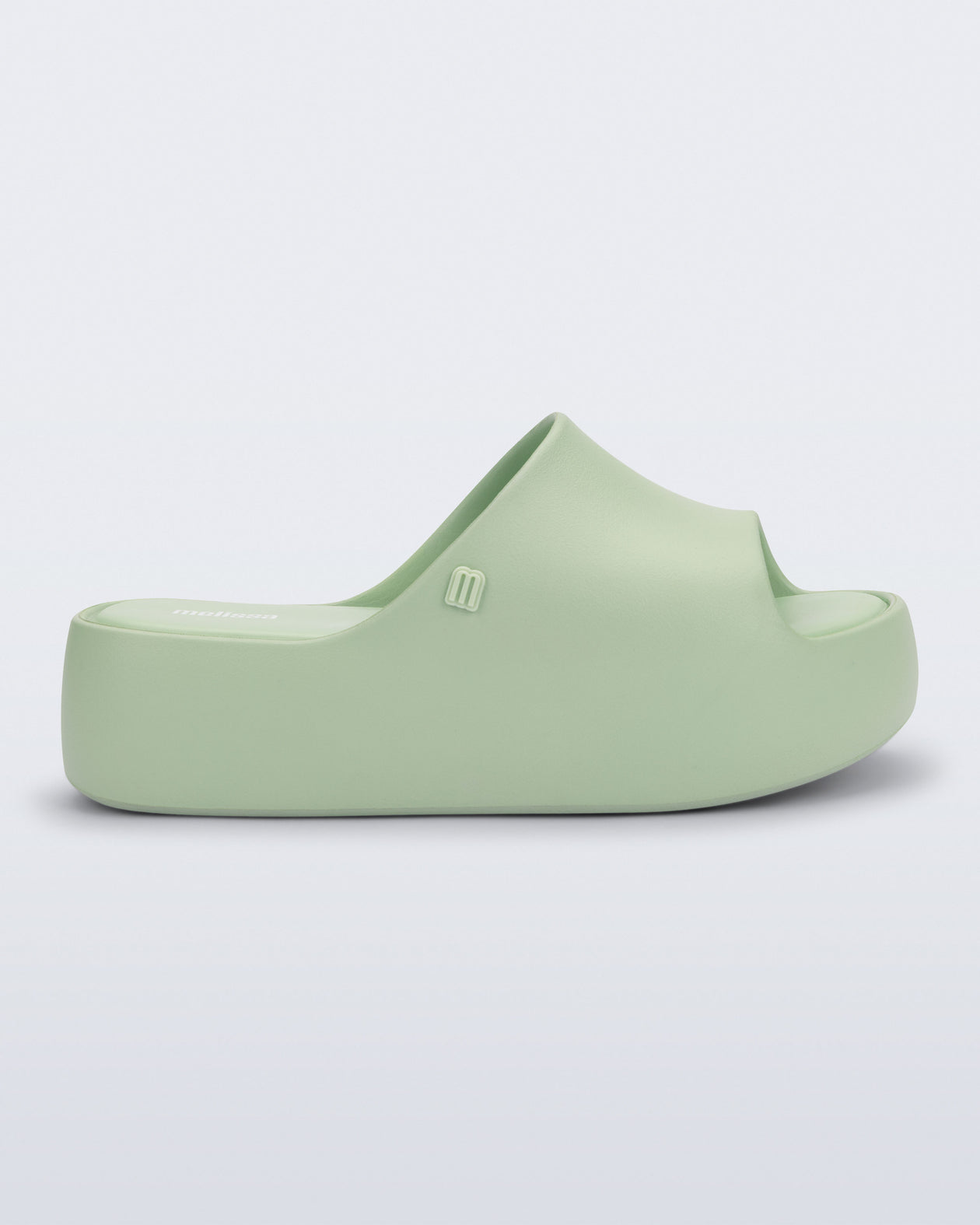 Side view of a light green Free Platform Slide sandal 