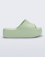 Side view of a light green Free Platform Slide sandal 