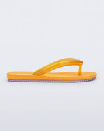Side view of a orange Flip Flop Airflow sandal with a clear orange strap and lilac bottom