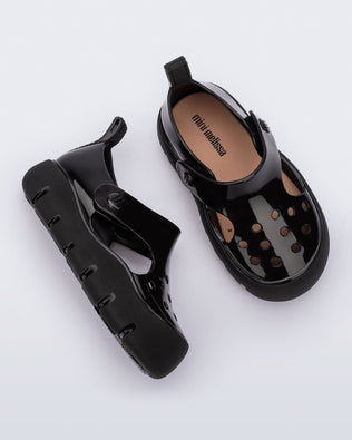 Top and side view of a pair of black Bowie baby sandals.