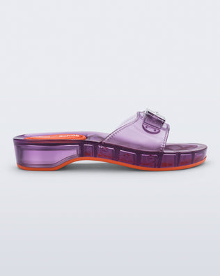 Side view of a clear lilac Pescura Heel + Scholl slide with top buckle