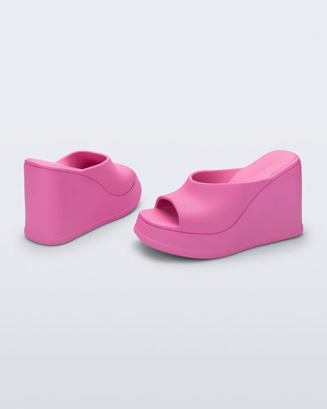 Back and angled view of a pair of pink Free Slip platform wedge heels