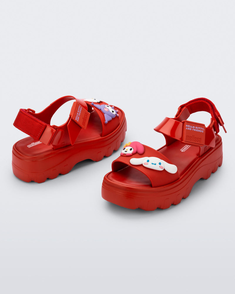Back and angled view of a pair of red Kick Off Sandals + Hello Kitty and Friends with Hello Kitty and Friends on the upper strap