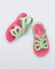 Side and angled view of a pair of green strap, pink sole Hip Butterfly baby sandals