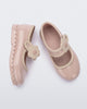 Side and top view of a pair of beige Hip Ballerina baby flats with strap with flower