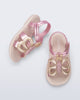 Side and angled view of a pair of pink strap, beige sole Hip Butterfly baby sandals