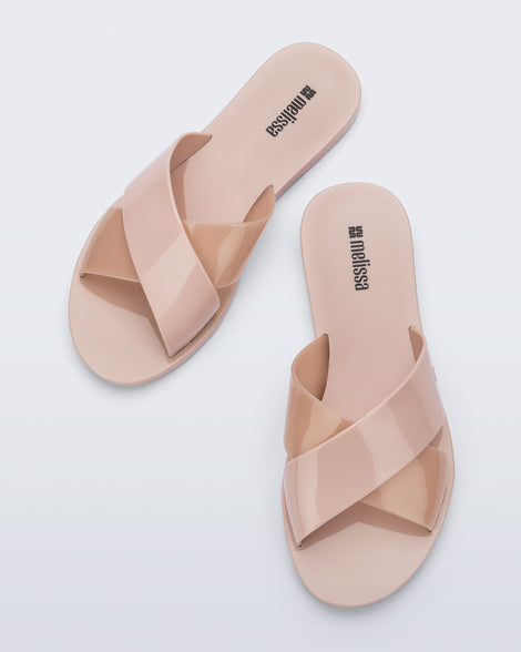 Top view of a pair of pink Essential Cross Slide sandals
