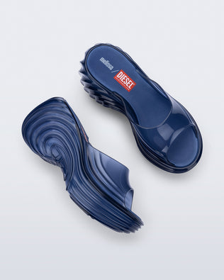 Side and top view of a pair of clear blue Quantum Platform sandals