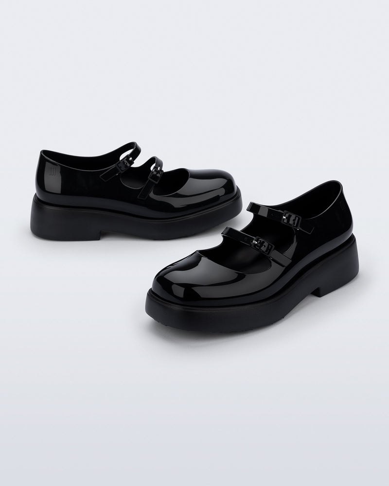 Side and angled view of a pair of black Farah Low Mary jane loafers