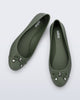 An angled top view of a pair of green Melissa flats with a bow detail with gold accents on the bow