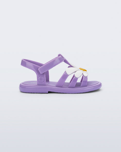 Side view of a purple Hip Bloom sandal with white flower on top