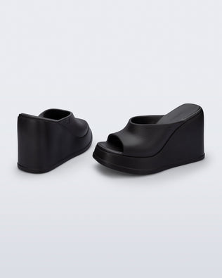 Back and angled view of a pair of black Free Slip platform wedge heels
