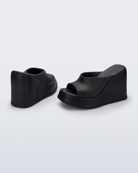 Back and angled view of a pair of black Free Slip platform wedge heels