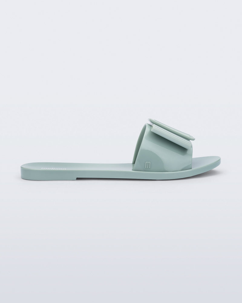 Side view of a blue green Babe slide sandal