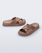 Side and angled view of a pair of brown Cozy Cross sandals with crisscross top straps